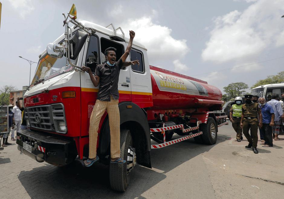 People queue to buy kerosene at a fuel station in Colombo