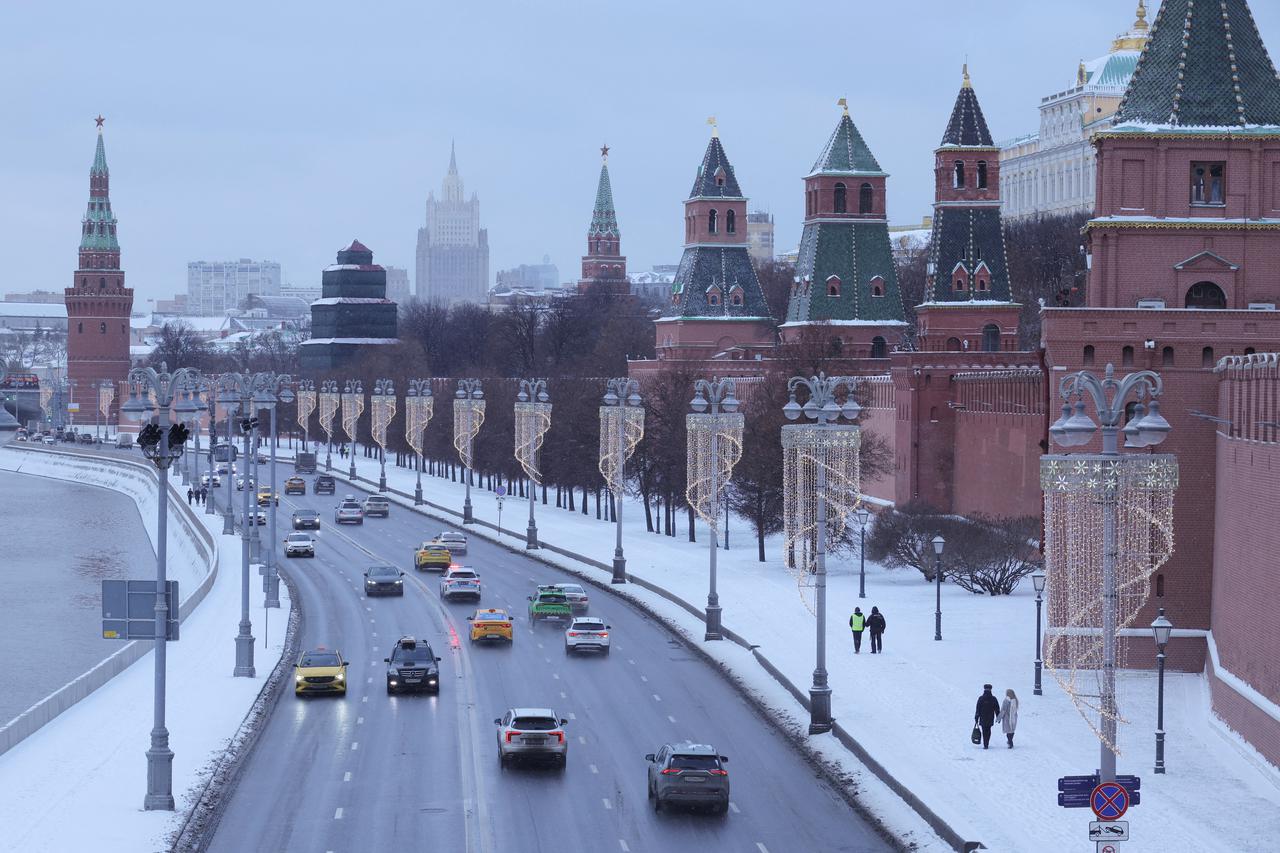 Cars drive along an embankment in Moscow