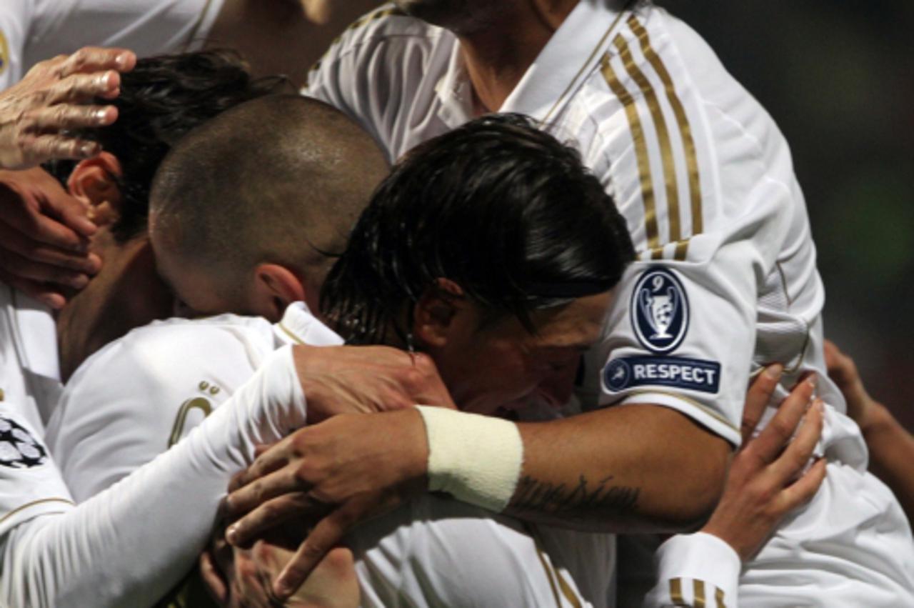 'Real Madrid football players celebrate after scoring their third and final goal during their UEFA Champions League first leg quarter-final football match against APOEL at the GSP Stadium in Nicosia o