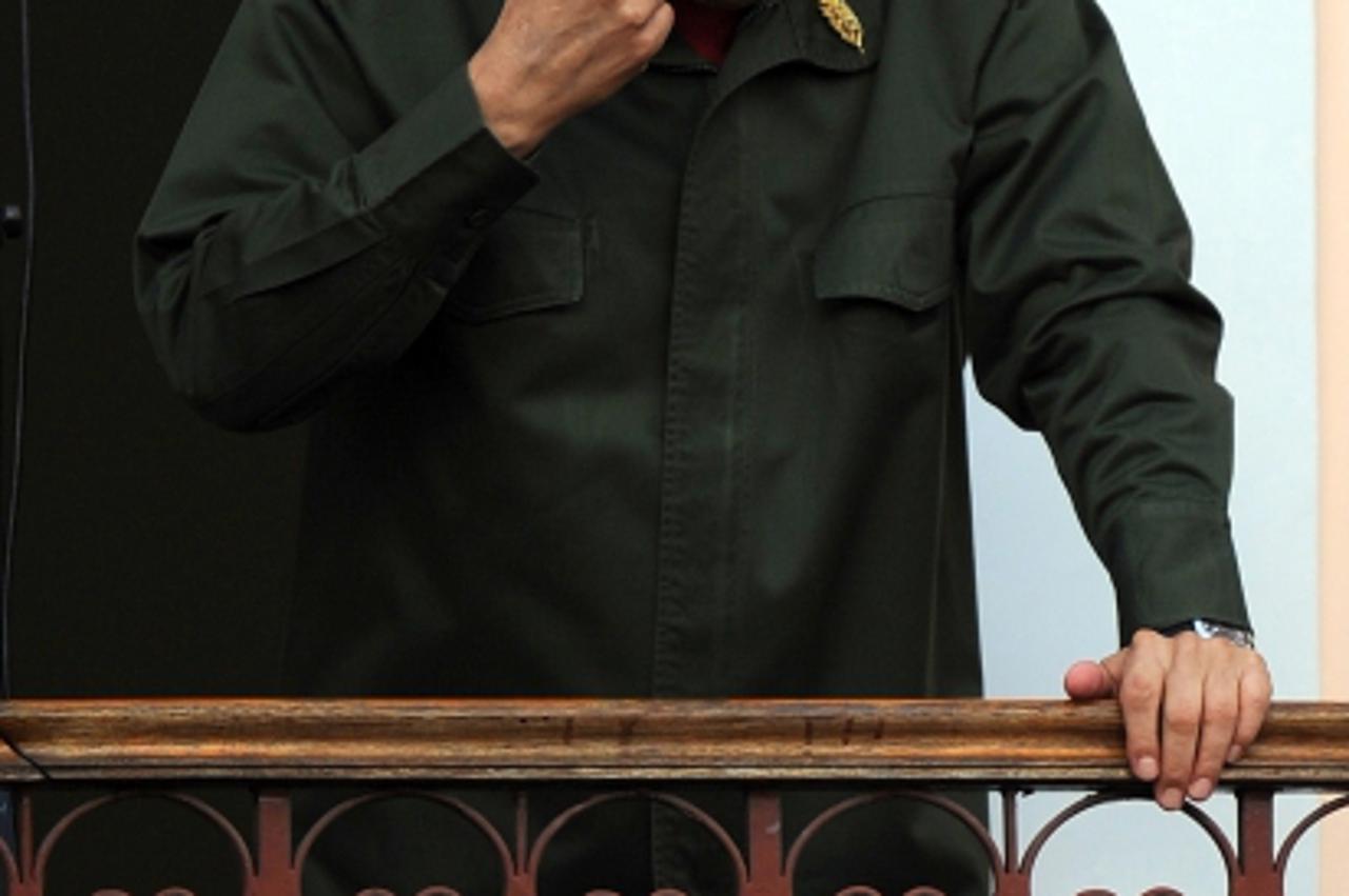 'Venezuelan President Hugo Chavez gestures to supporters at Miraflores presidential palace in Caracas on July 4, 2011. Chavez returned to Venezuela Monday after spending three weeks in Cuba, where he 