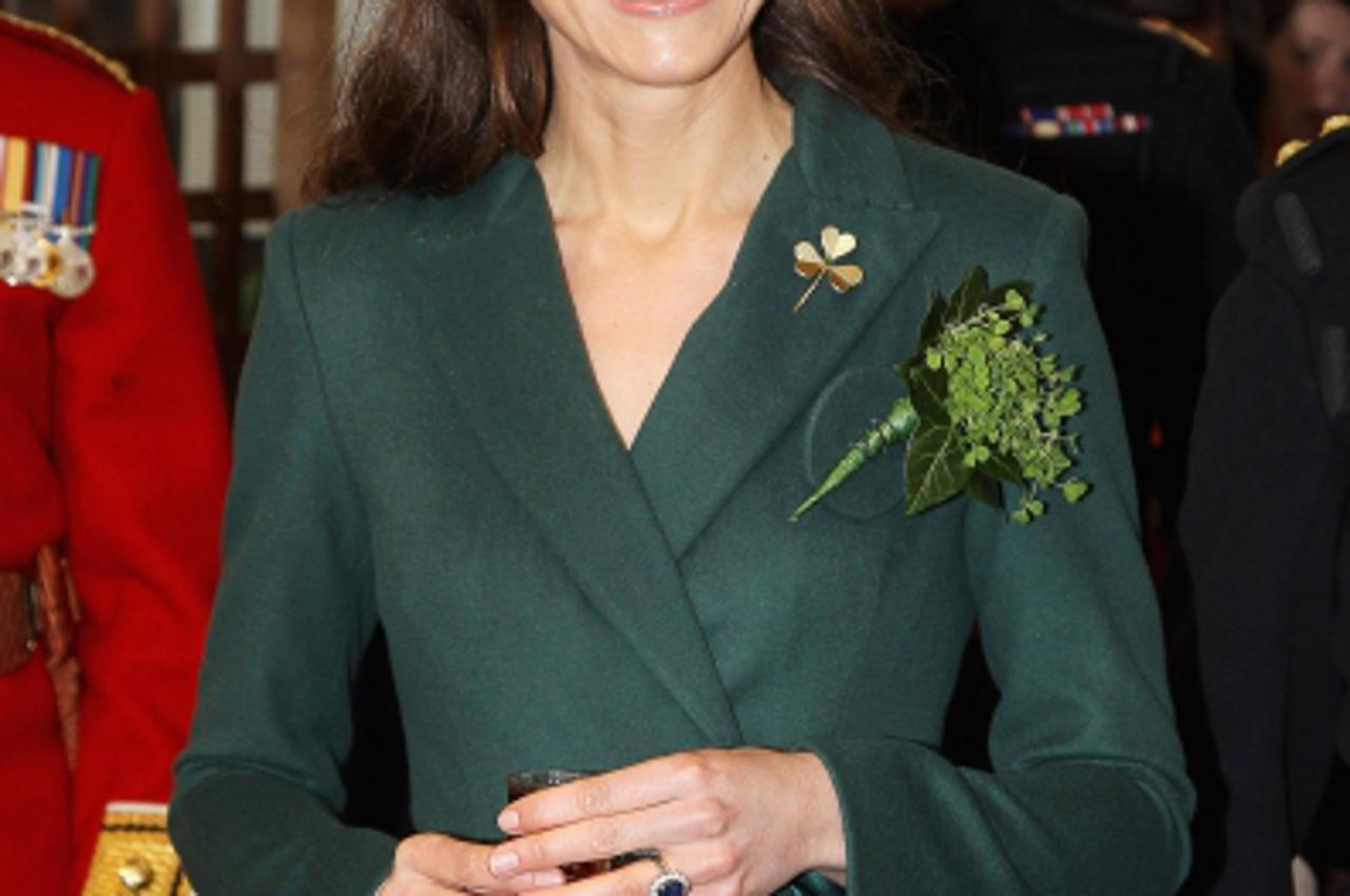 'Britain\'s Catherine, Duchess of Cambridge, holds a glass of Harvey\'s Bristol Creme in the Junior\'s Mess as she visits Aldershot Barracks on St Patrick\'s Day in Aldershot on March 17, 2012.  AFP P