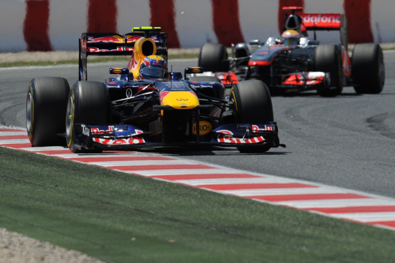 'Red Bull Racing\'s German driver Sebastian Vettel (L) and McLaren Mercedes\' British driver Lewis Hamilton drive at the Circuit de Catalunya on May 22, 2011 in Montmelo on the outskirts of  Barcelona