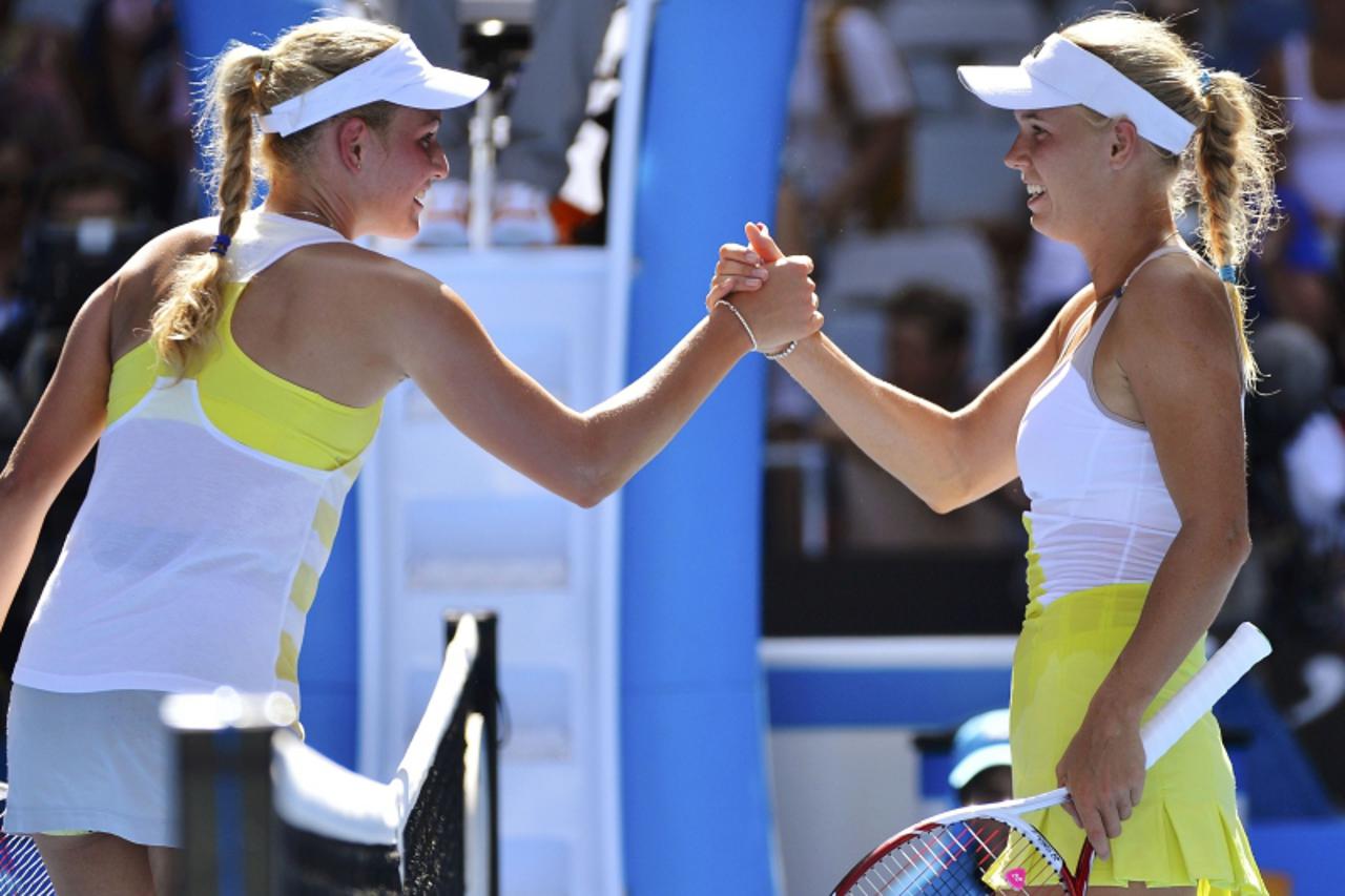'Caroline Wozniacki of Denmark shakes hands with Donna Vekic of Croatia (L) after defeating her in their women\'s singles match at the Australian Open tennis tournament in Melbourne January 17, 2013. 