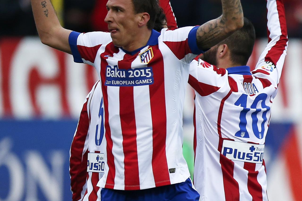Atletico Madrid's Mario Mandzukic celebrates after scoring a goal against Real Madrid during their Spanish first division soccer match at the Vicente Calderon stadium in Madrid, February 7, 2015.      REUTERS/Juan Medina (SPAIN  - Tags: SPORT SOCCER)