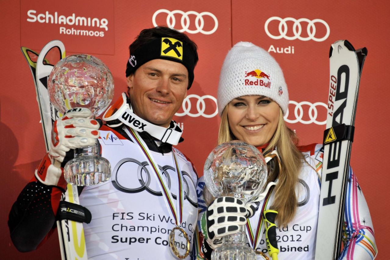 'Lindsey Vonn from the US (R) and Croatian Ivica Kostelic pose with their trophy at the Alpine ski World Cup finals on March 17, 2012 in Schladming. Vonn won the womens\' super combined trophy and Kos