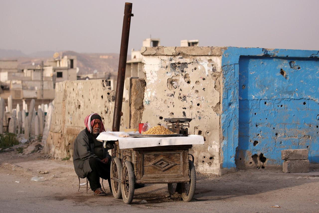 A street vendor waits for customers in Douma