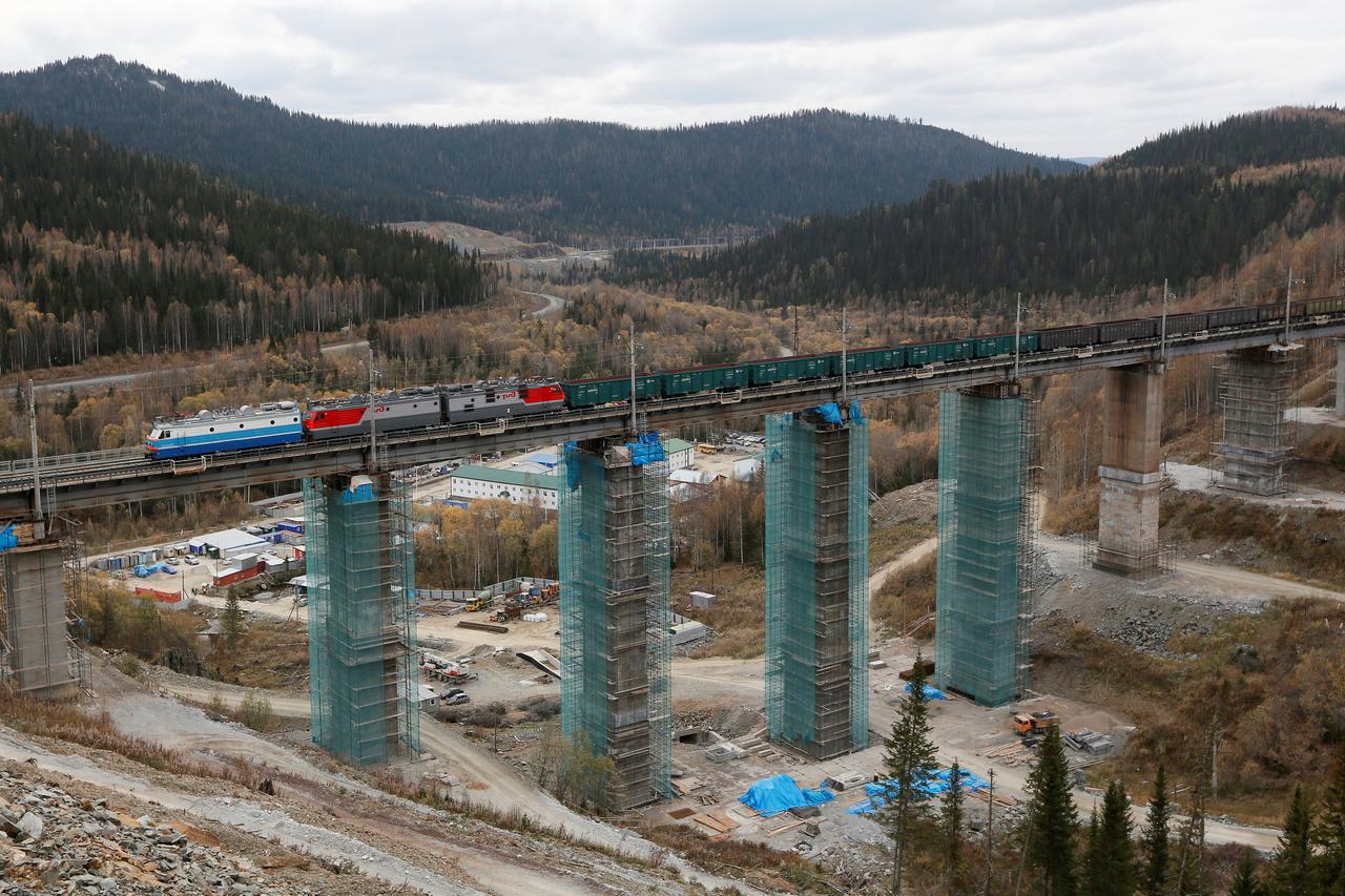 A train moves along the Kozinsky Viaduct, one of Russia's highest railway bridges which is under reconstruction, at the southern branch of the Trans-Siberian Railway in the Taiga in the Eastern Sayan Mountain Ridge area near Dzheb railway station in Krasn