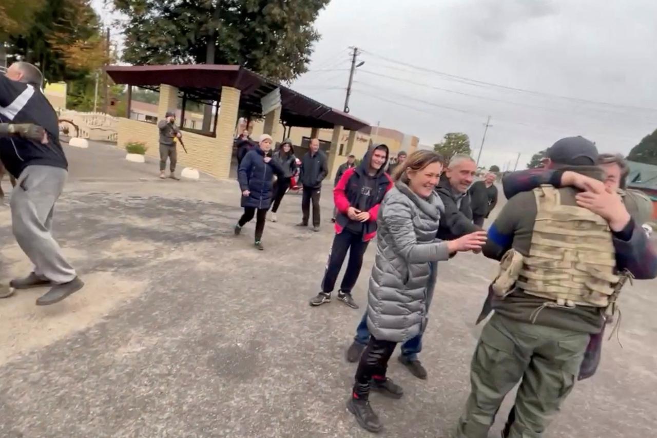 Residents greet soldiers in a location given as Kozacha Lopan