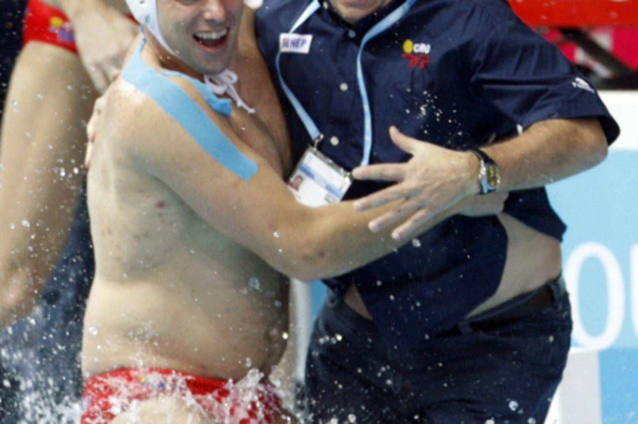 'Radko Rudic (R), head coach of the Croatian water polo team, and team player Mile Smodlaka jump into the pool as their team wins the World Aquatics Championships in Melbourne April 1, 2007.   REUTERS