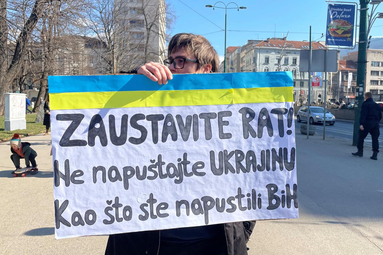 Ajna Jusic carries a placard during a protest to send messages of support to Ukraine in Sarajevo