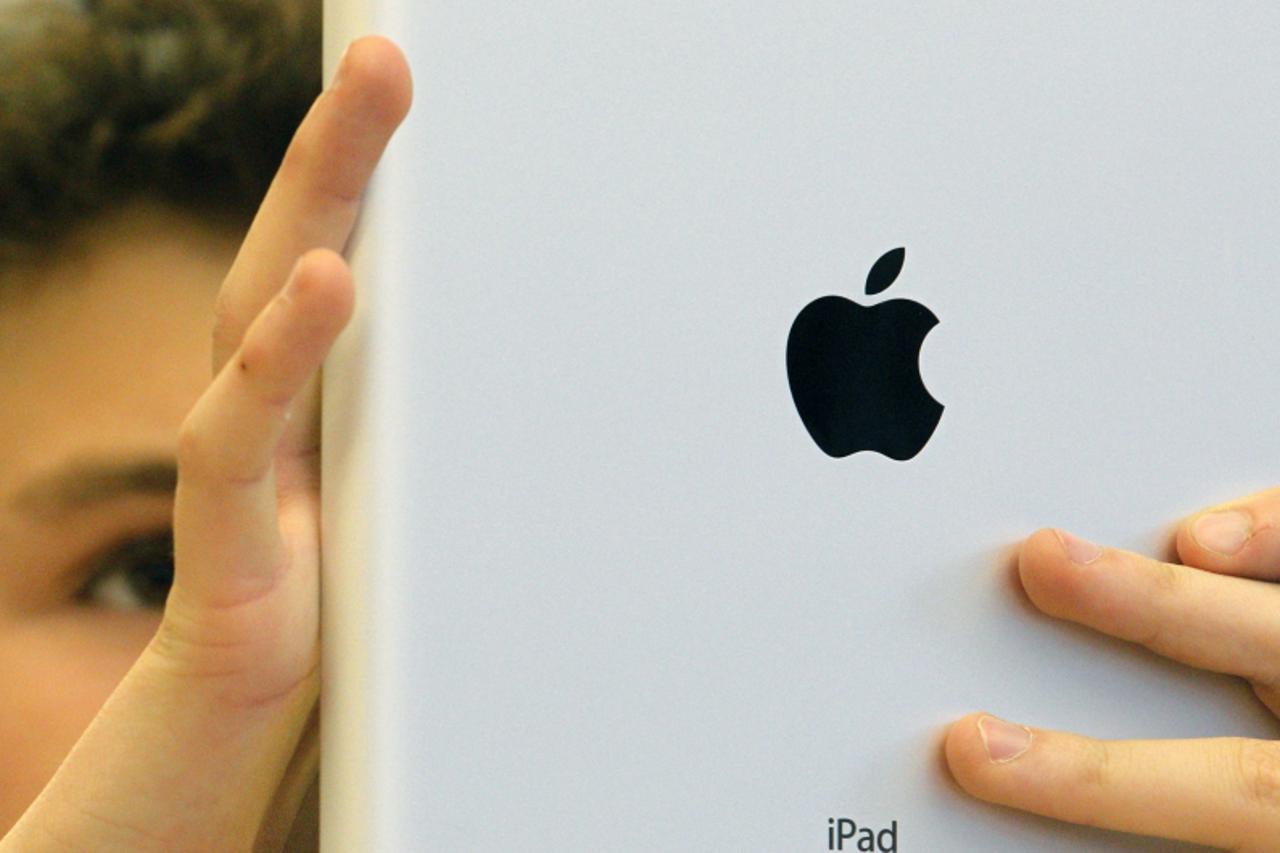 'A young customer looks at Apple\'s iPad 2 at Zurich\'s Apple store after its official launch for direct purchase in Switzerland March 25, 2011. Hundreds of customers queued outside Apple stores in As