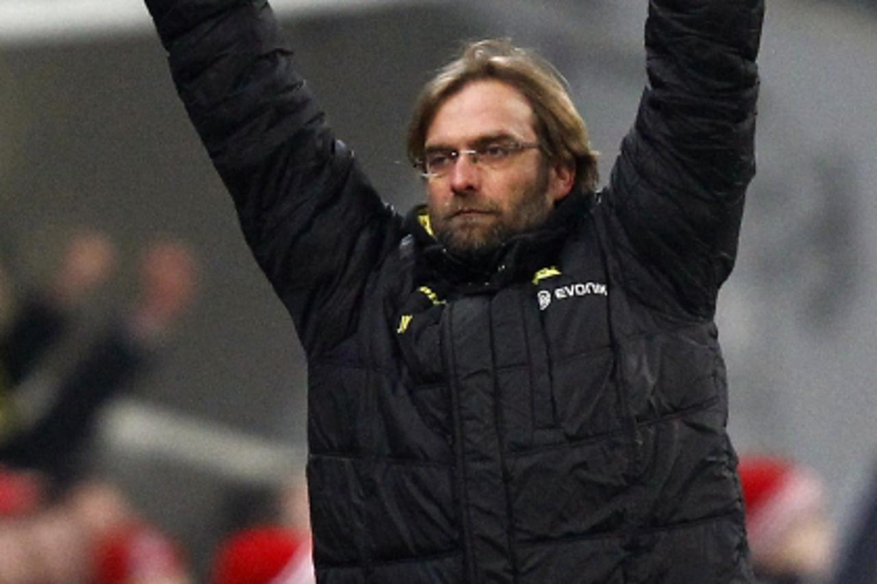 \'Juergen Klopp, coach of Borussia Dortmund celebrates his team\'s third goal against Bayern Munich during their German first division Bundesliga soccer match in Munich, February 26, 2011.   REUTERS/K
