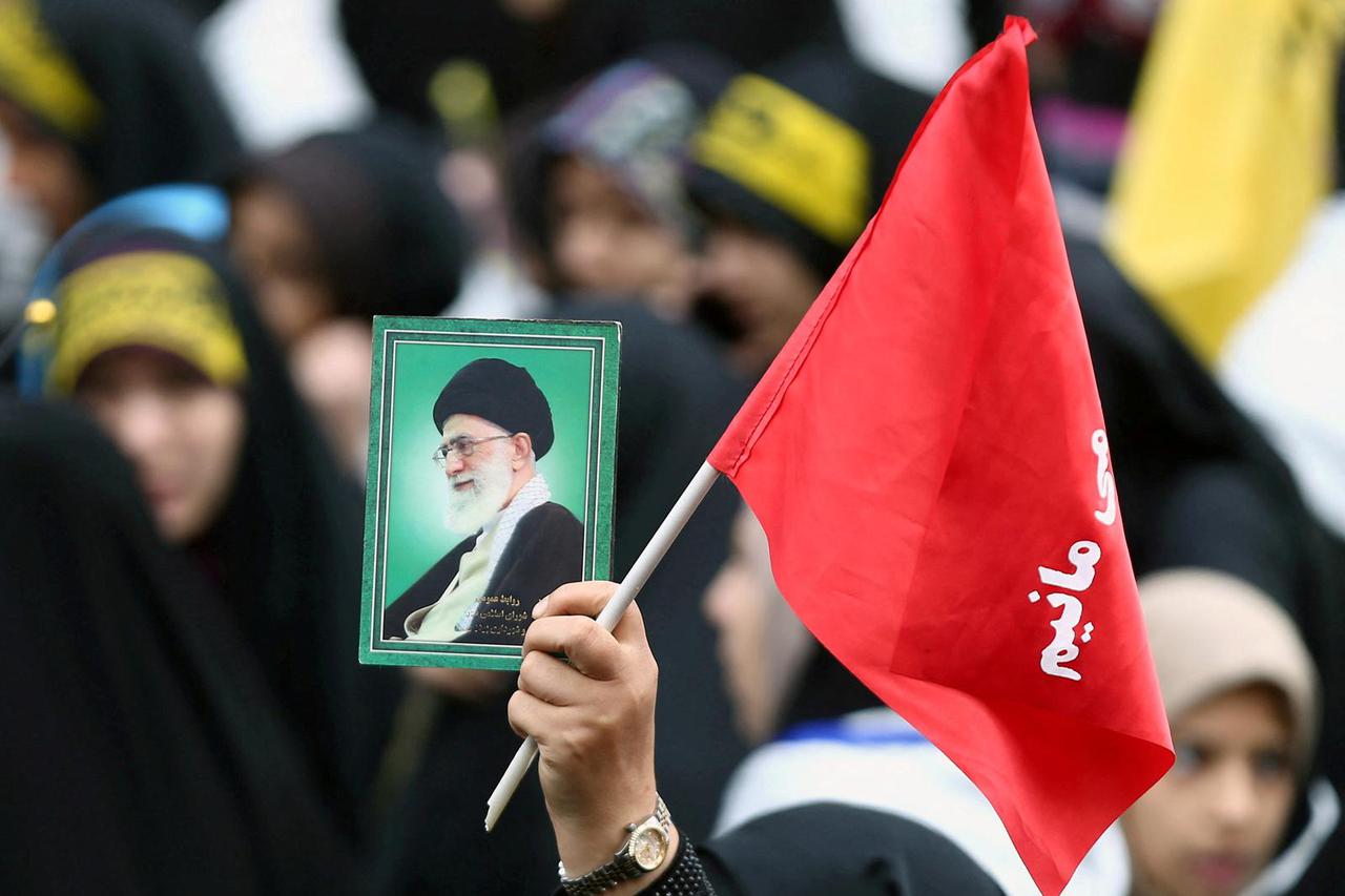 FILE PHOTO: An Iranian protester holds the picture of Iranian Supreme Leader Ayatollah Ali Khamenei as she attends an anti U.S. demonstration, marking the 40th anniversary of the U.S. embassy takeover, near the old U.S. embassy in Tehran