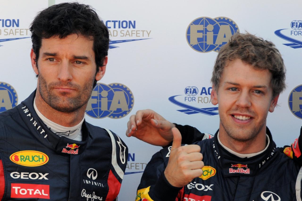 '(L to R) Red Bull Racing\'s Australian driver Mark Webber and Red Bull Racing\'s German driver Sebastian Vettel celebrate in the parc ferme at the Circuit de Monaco on May 28, 2011 in Monte Carlo aft