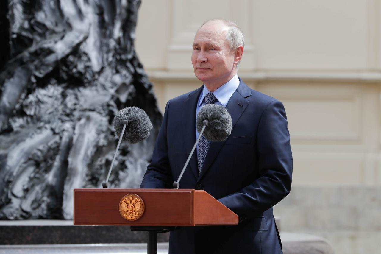 Russian President Vladimir Putin takes part in a ceremony unveiling a monument in Leningrad Region