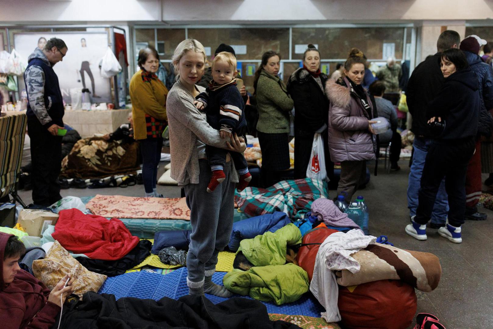 Katarina Bovt holds son son Nikita in a metro station in northern Kharkiv where they live to shelter from shelling in their neighbourhood as Russia's attack on Ukraine continues, Ukraine, March 24, 2022. Bovt has moved to the underground shelter three weeks ago. REUTERS/Thomas Peter Photo: Thomas Peter/REUTERS
