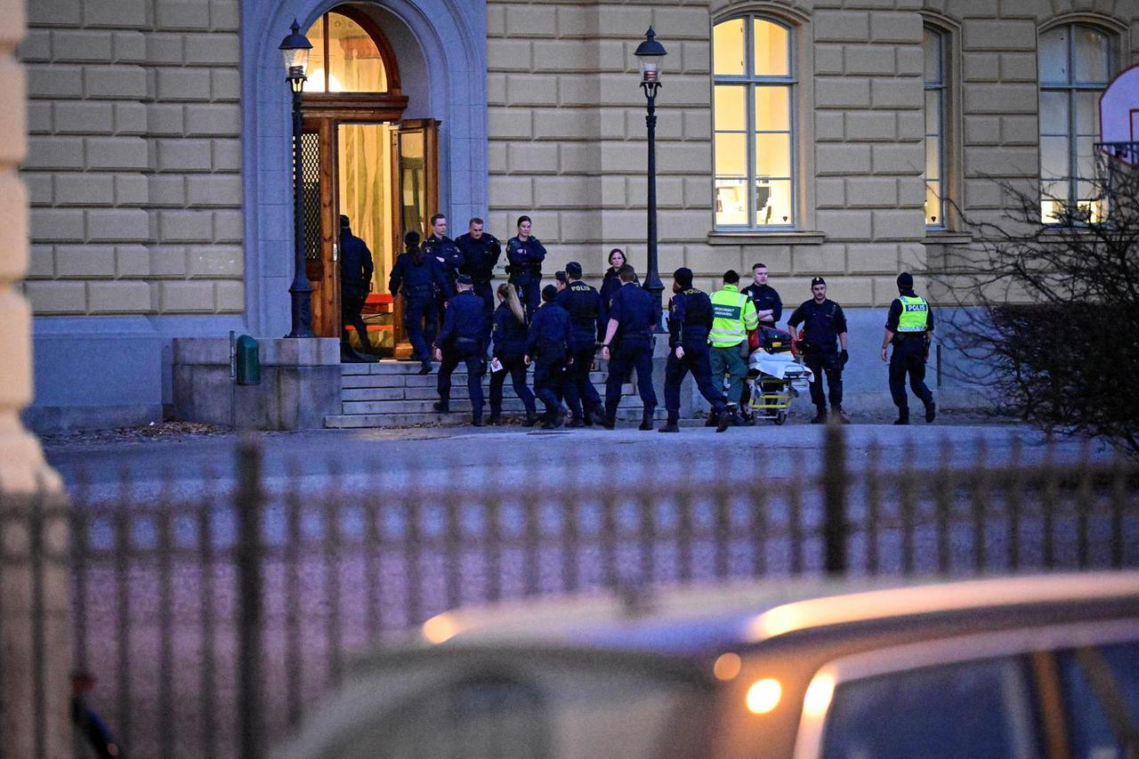 Police officers and ambulance personnel attend at the scene of a crime by a school in Malmo