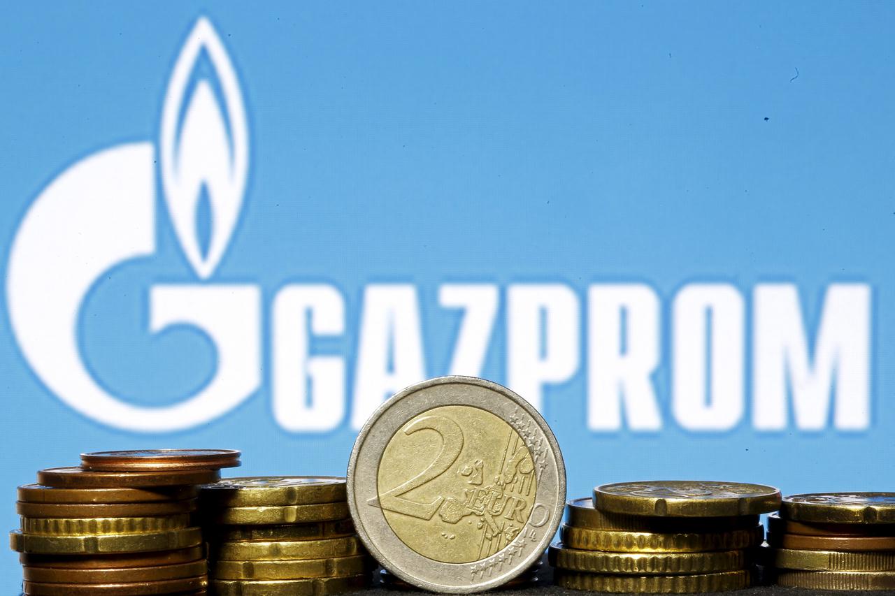 Euro coins are seen in front of displayed logo of Gazprom in this picture illustration taken in Zenica, April 21, 2015. The European Union will launch a legal attack on Russian gas giant Gazprom this week, ramping up tensions with Moscow, when antitrust a