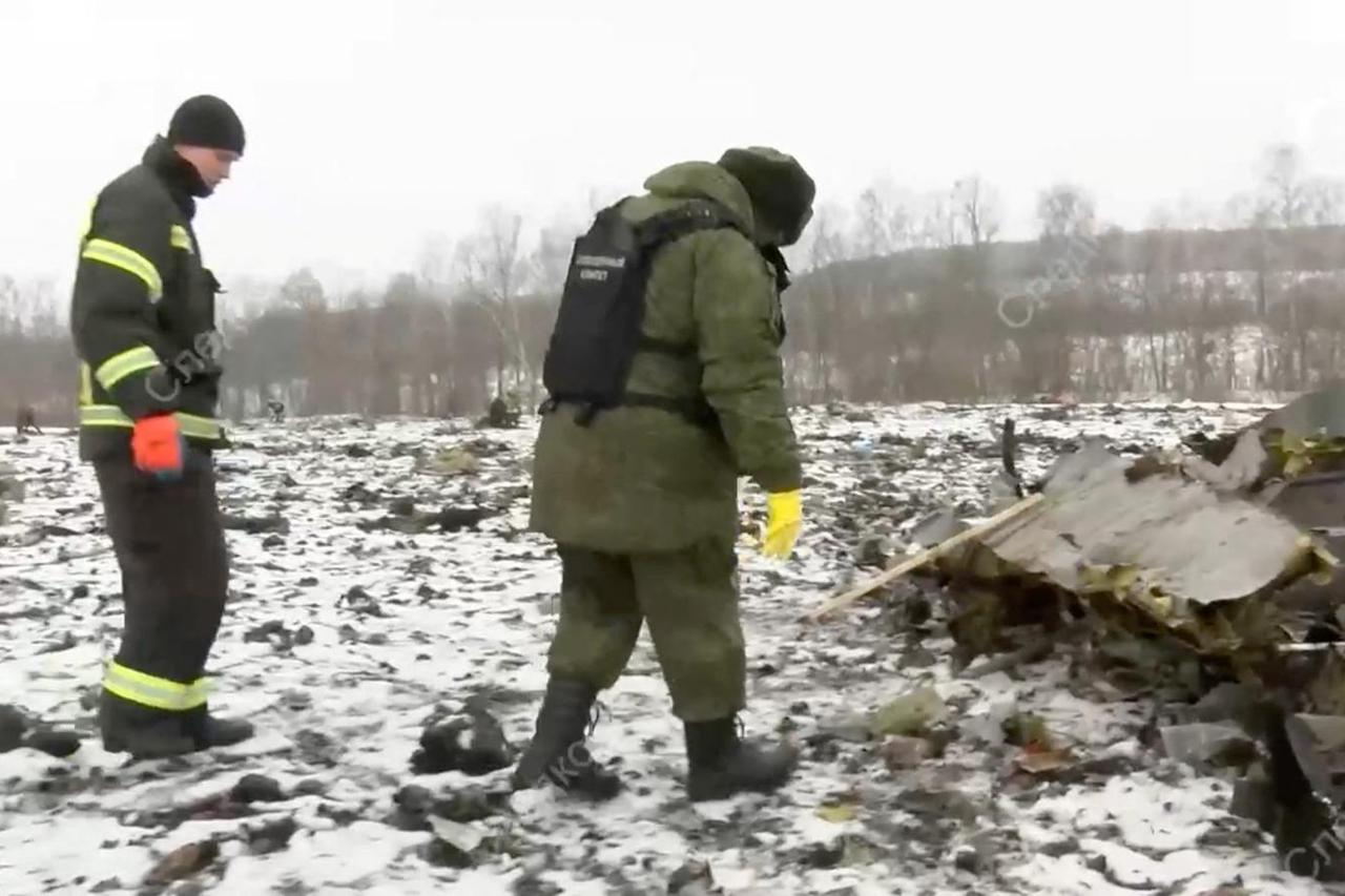 Investigators work at the crash site of Russian Il-76 military plane in Belgorod region