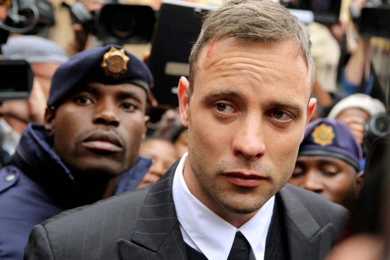 FILE PHOTO: Olympic and Paralympic track star Oscar Pistorius leaves court after appearing for the 2013 killing of his girlfriend Reeva Steenkamp