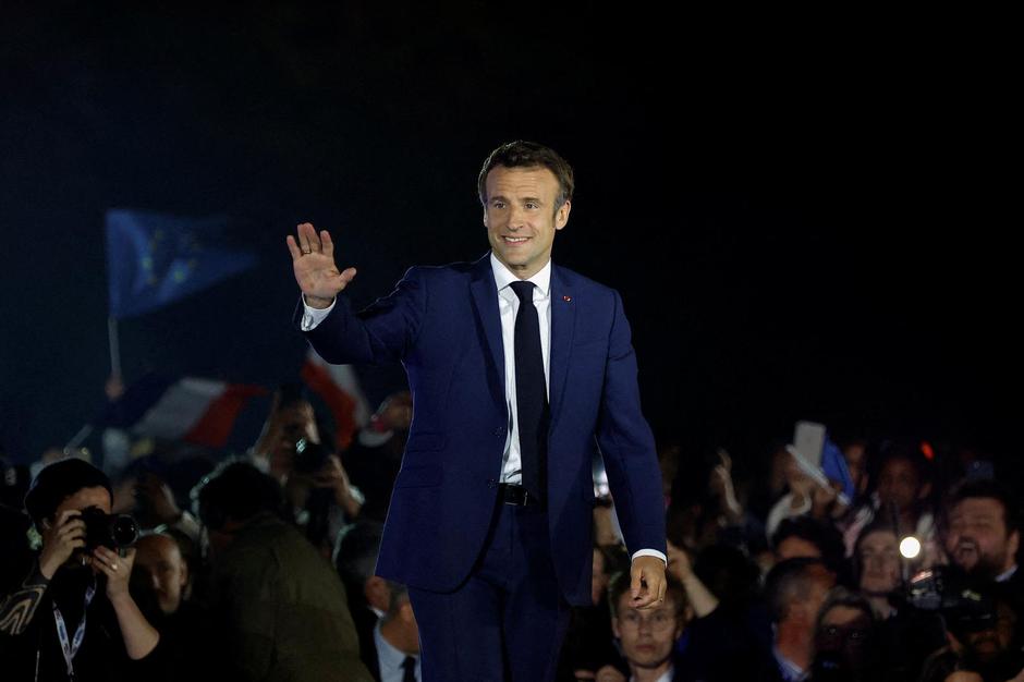 FILE PHOTO: Emmanuel Macron waves to his supporters after being re-elected as French president, in Paris, France