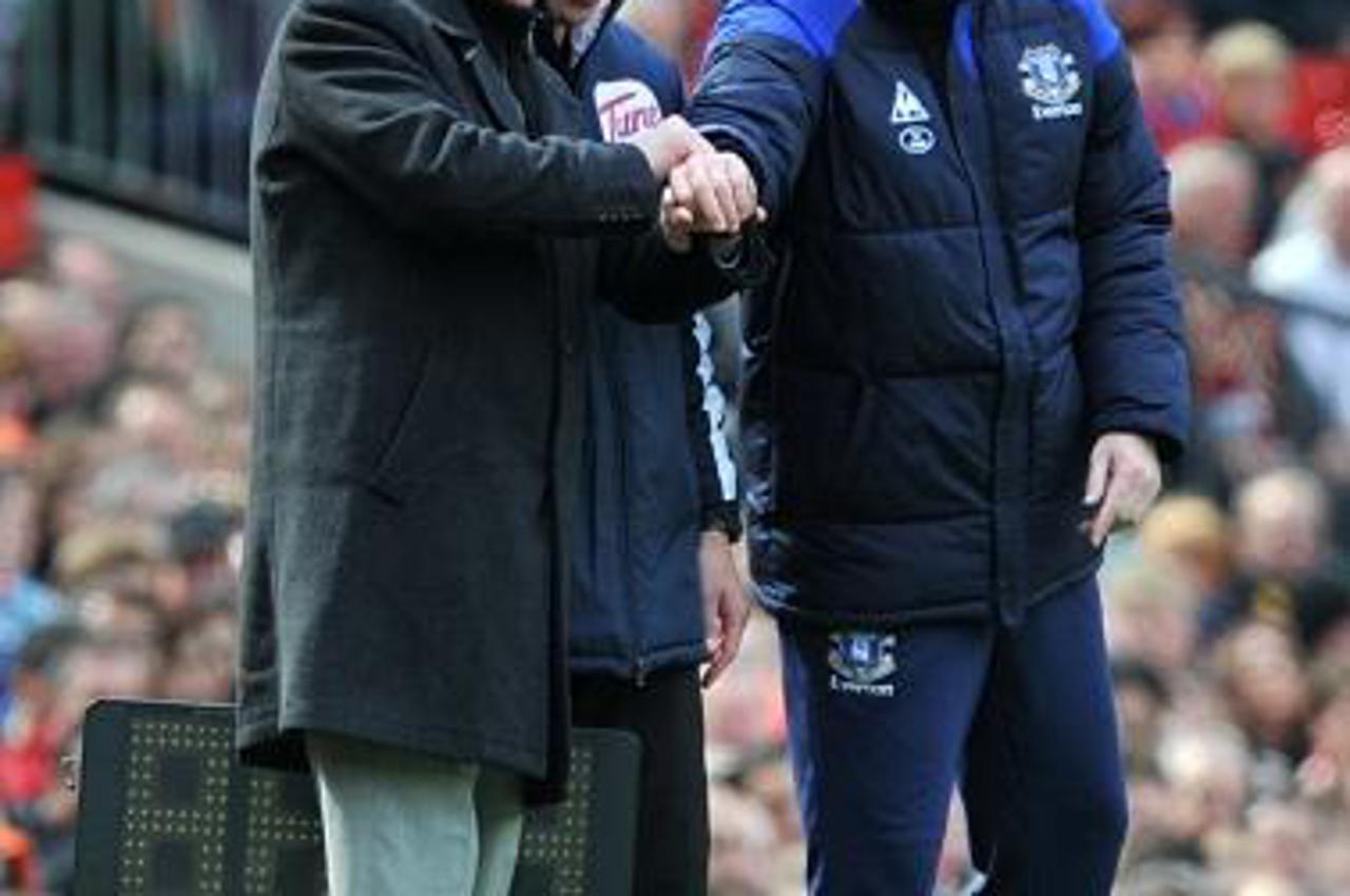 'File photo dated 22/04/2012 of Manchester United\'s manager Sir Alex Ferguson and Everton\'s manager David Moyes laugh with the fourth official. PRESS ASSOCITAION Photo. Issue date: Wednesday May 8, 