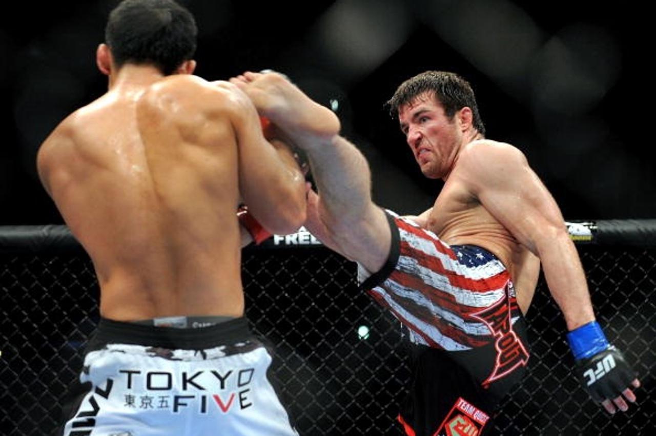 'LOS ANGELES, CA - OCTOBER 24:  UFC fighter Chael Sonnen (R) battles with UFC fighter Yushin Okami (L) during their Middleweight bout at UFC 104: Machida vs. Shogun at Staples Center on October 24, 20
