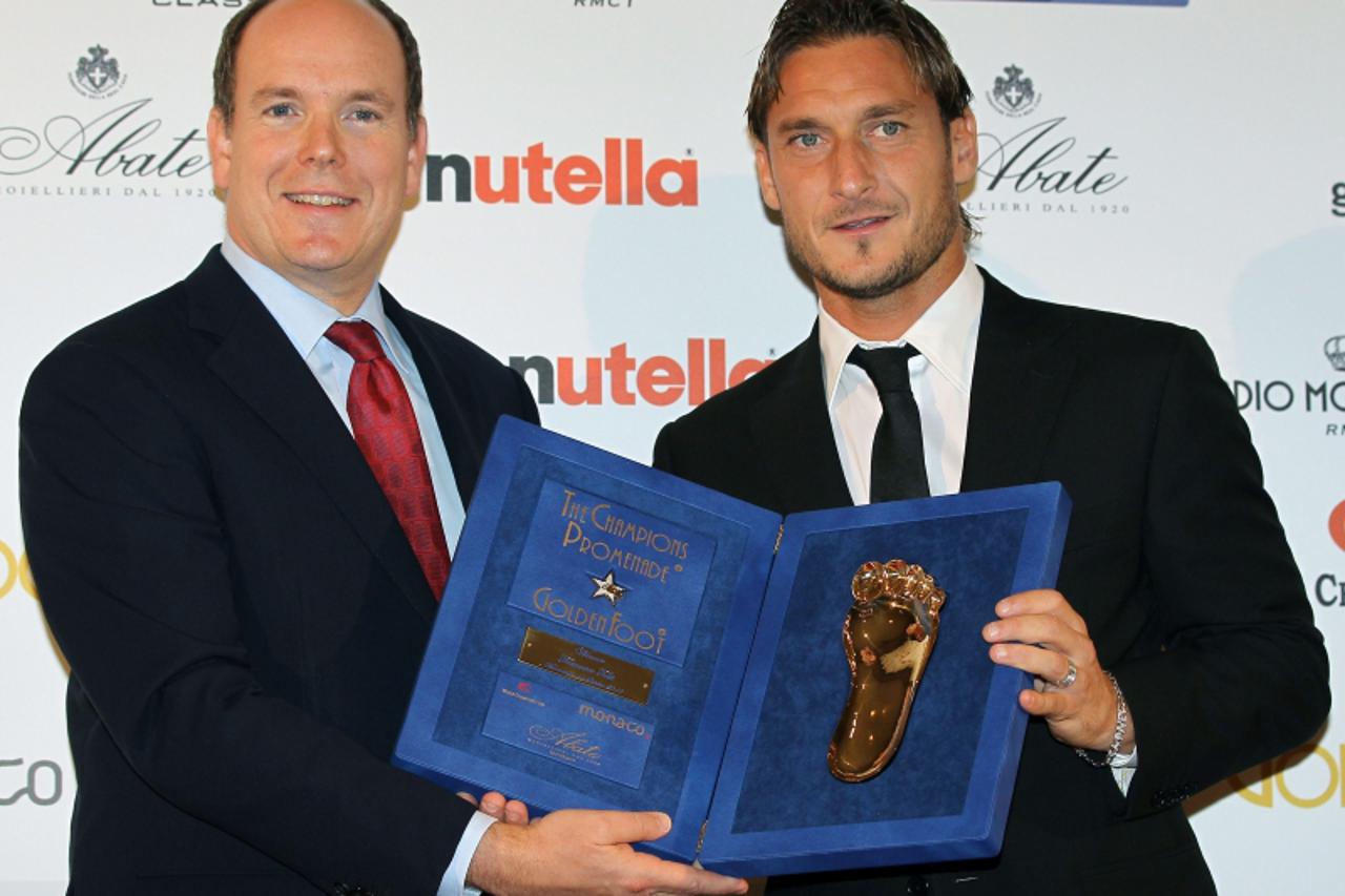 'Italian Francesco Totti football player receives from Prince Albert II of Monaco the 2010 Golden Foot Award on October 11, 2010 in Monaco. The Golden Foot award is an international career award given
