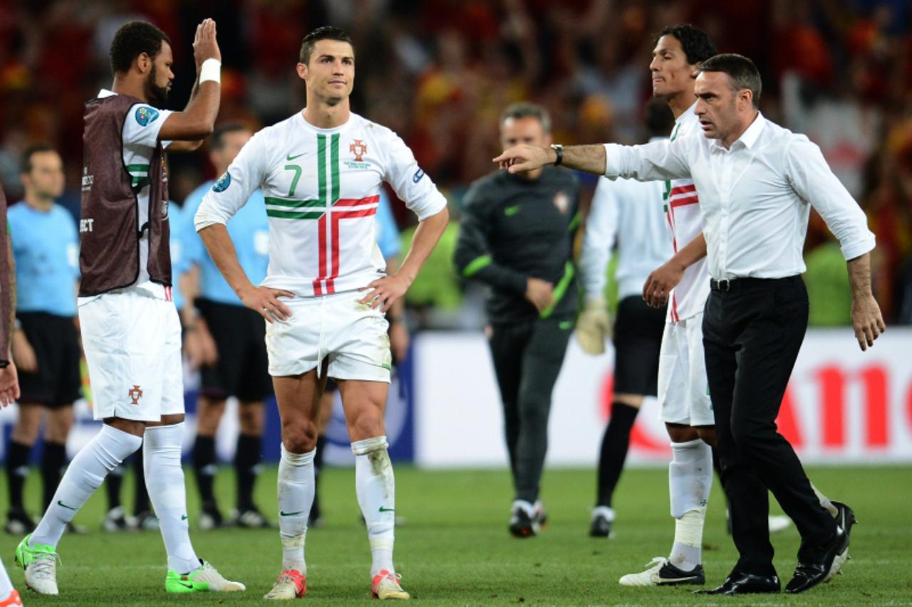 'Portuguese forward Cristiano Ronaldo (C) reacts next to Portuguese headcoach Paulo Bento (R) at the end of the penalty shoot out of the Euro 2012 football championships semi-final match Portugal vs. 