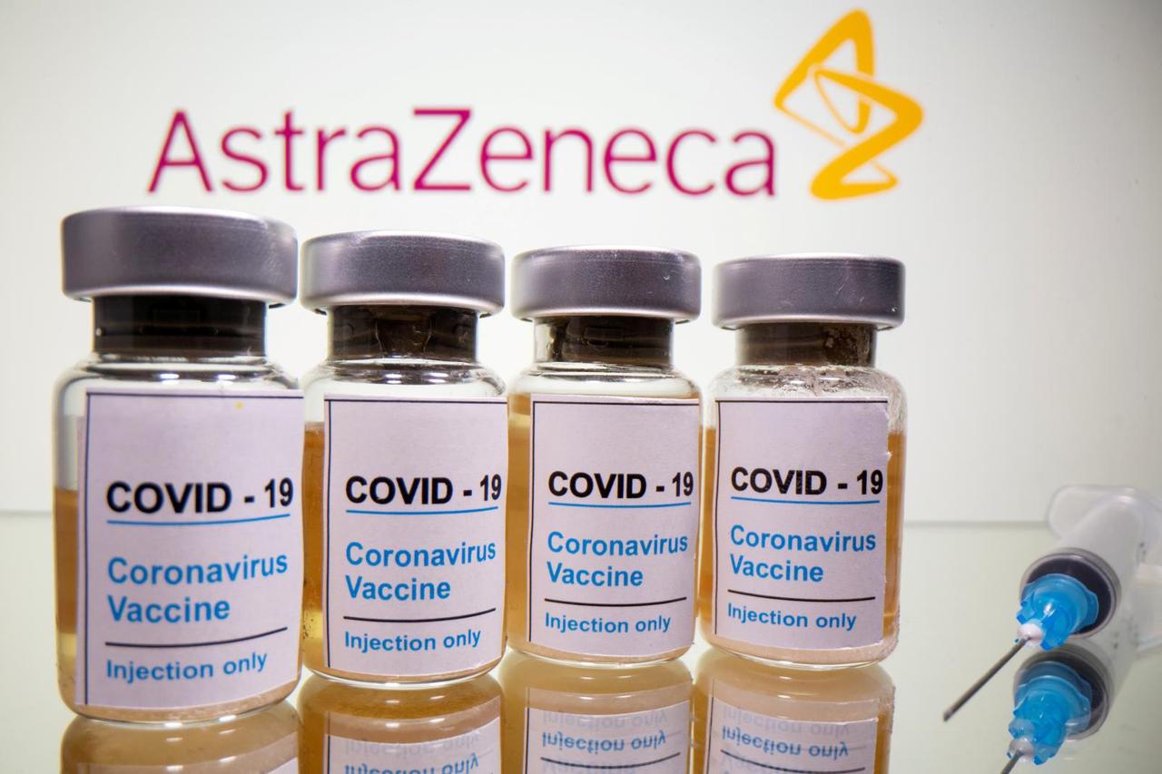 FILE PHOTO: FILE PHOTO: FILE PHOTO: Vials and medical syringe are seen in front of AstraZeneca logo in this illustration