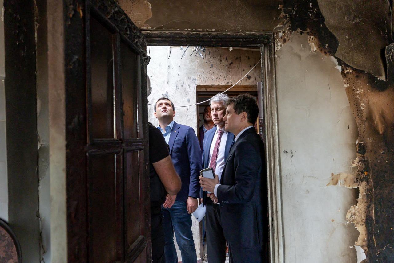 Romanian President Nicusor Dan visits the site of an explosion in a residential block of flats following a reported drone strike in Galati