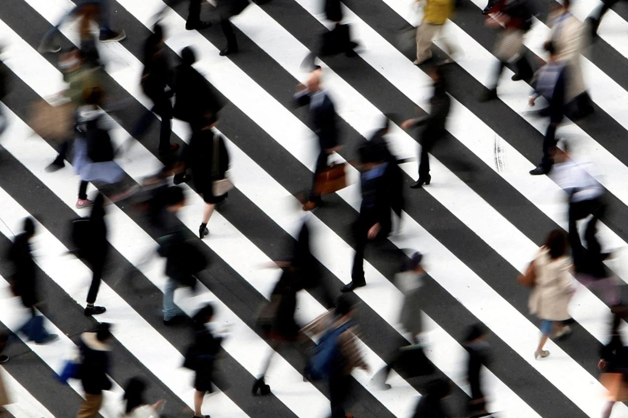 FILE PHOTO: People cross a street in Tokyo