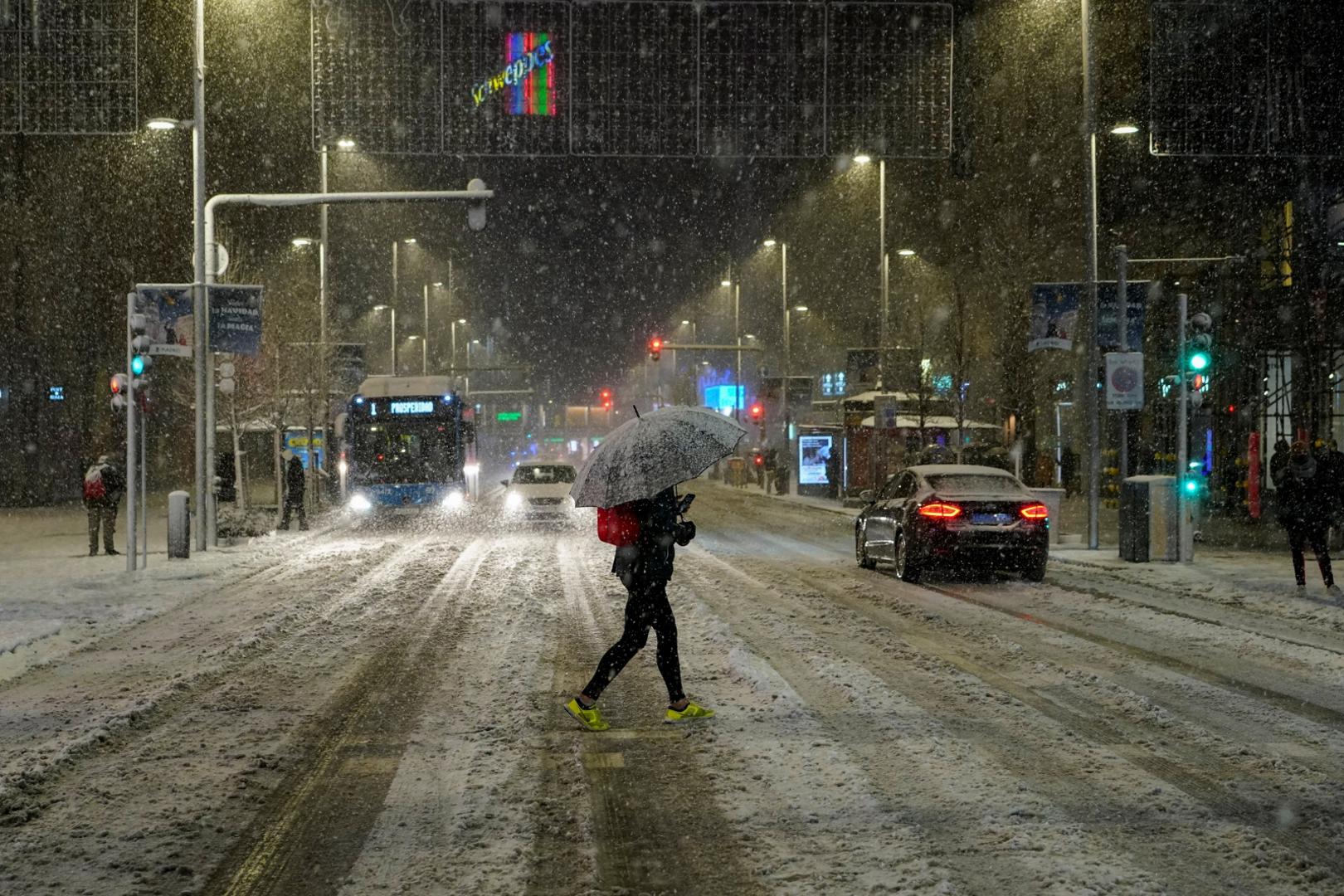 Snowfall in Madrid A person with an umbrella crosses the Gran Via street during snowfall in Madrid, Spain, January 8, 2021. REUTERS/Juan Medina JUAN MEDINA