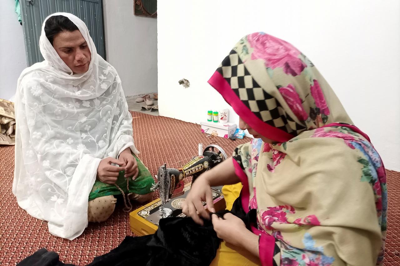 Rani Khan looks at one of her students during a tailoring lesson in Islamabad
