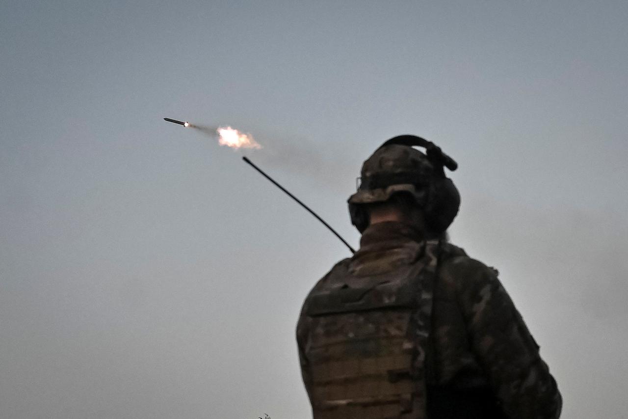 A member of company tactical group "Steppe Wolves" of the Voluntary Formation of the Zaporizhzhia Territorial Community fires a handmade small multiple rocket launch system toward Russian troops near a front line