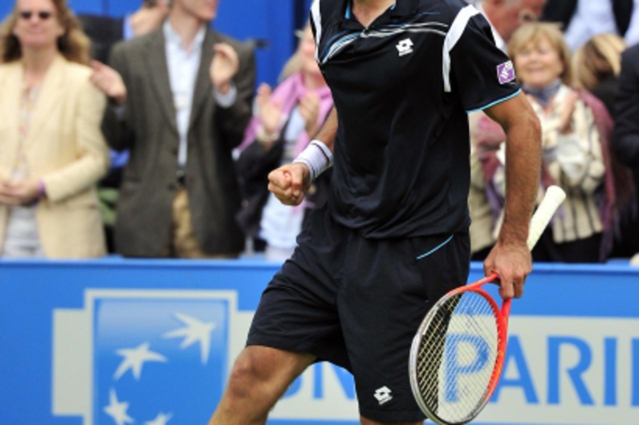 'Ivan Dodig of Croatia celebrates winning against Jo-Wilfried Tsonga of France during their men\'s singles third round match on the fourth day of the Aegon Championships tennis tournament at the Queen