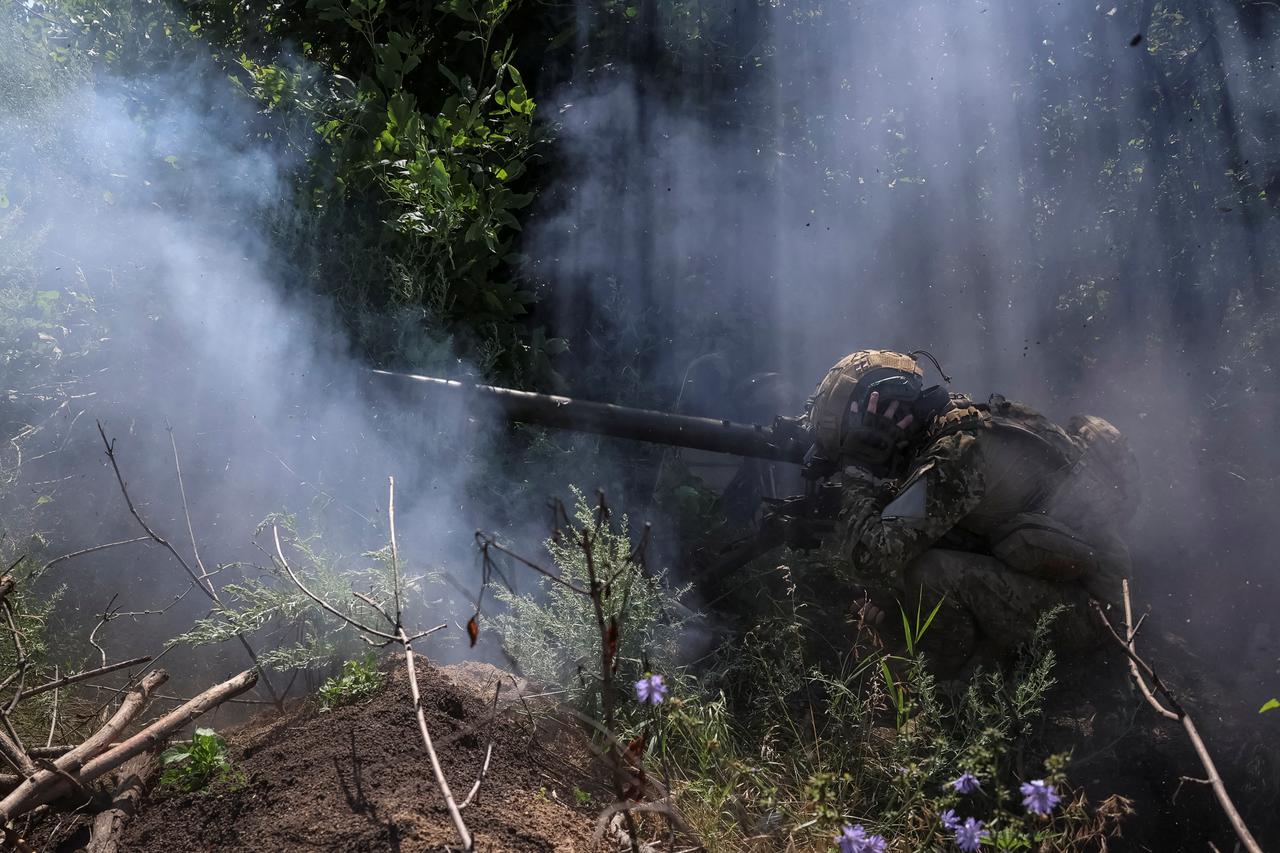 Ukrainian service members fire an anti-tank grenade launcher at a front line near the city of Bakhmut