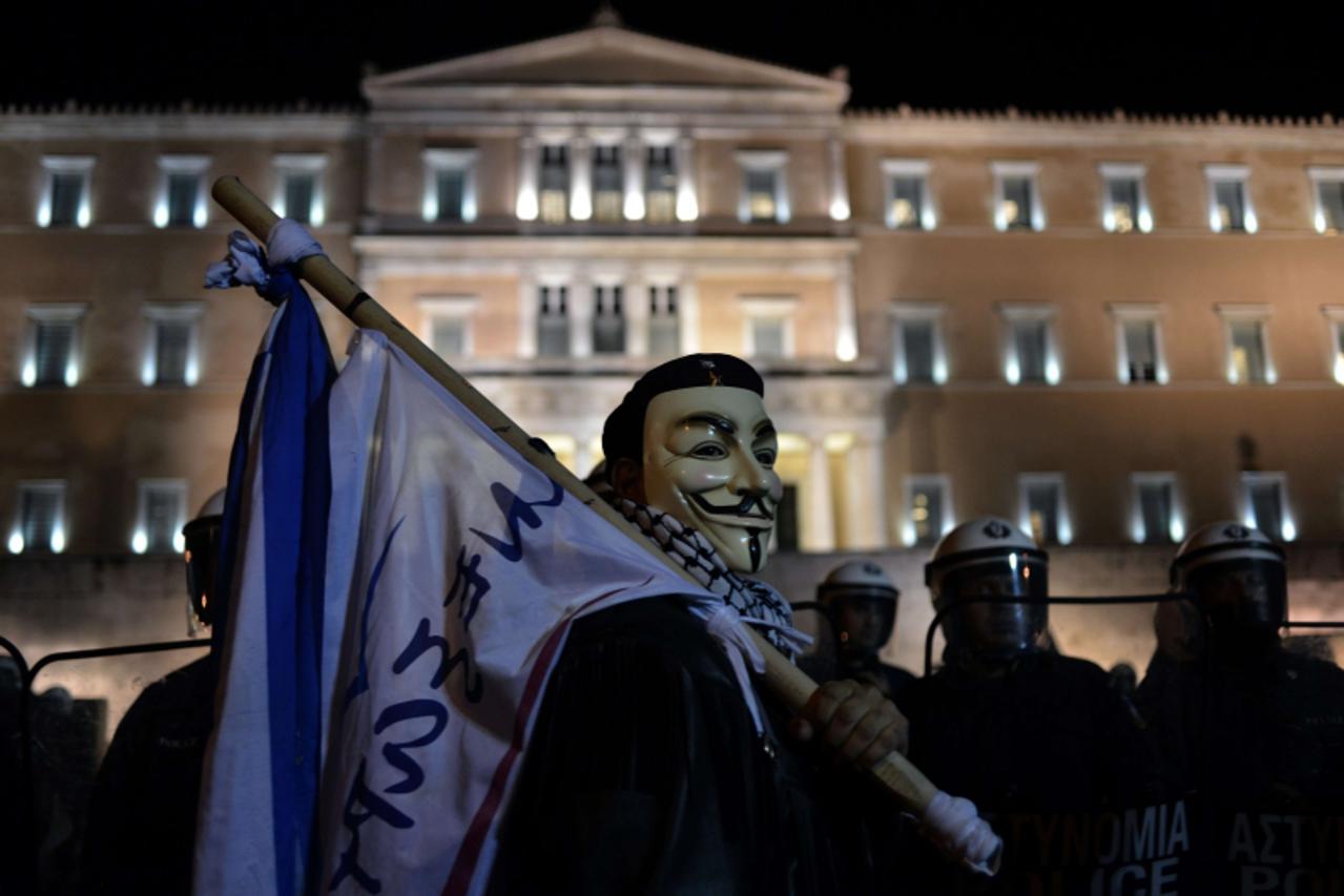 'Protesters demonstrate outside the Greek parliament against the new austerity measures in Athens on November 11, 2012. Thousands of protesters massed outside Greece\'s parliament Sunday as lawmakers 