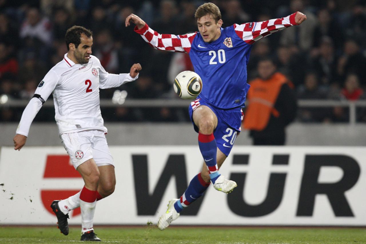 \'26.03.2011., Tbilisi, Gruzija - Kvalifikacijska utakmica za Europsko prvenstvo 2012. Hrvatska - Gruzija.Nikica Jelavic i Lasha Salukvadze. Photo: Igor Kralj/PIXSELL\'