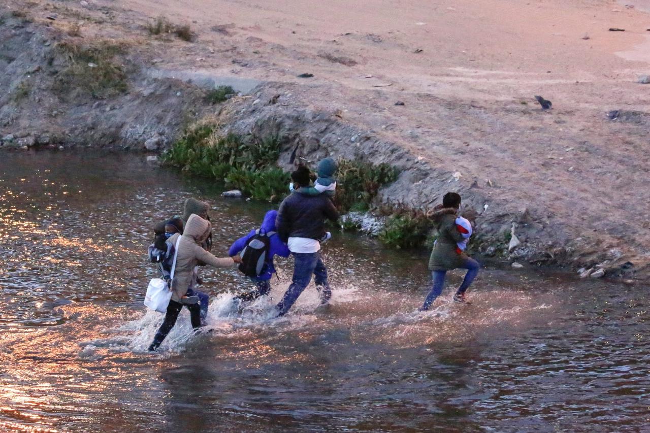 Migrants cross the Rio Bravo river to turn themselves in to U.S Border Patrol agents to request for asylum in El Paso, Texas, U.S., as seen from Ciudad Juarez