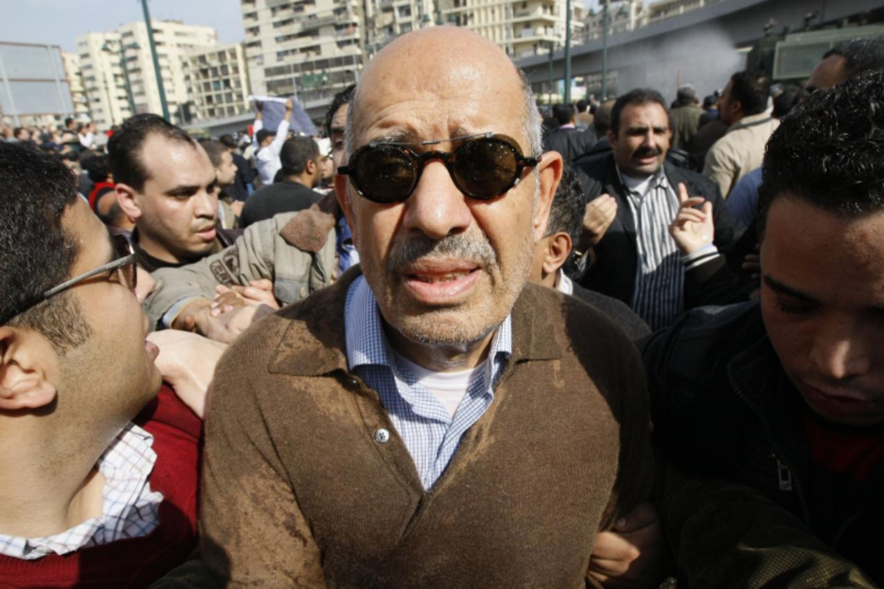 'Egyptian Leading dissident and former UN nuclear watchdog Chief Mohamed ElBaradei is surround by fellow demonstrators on January 28, 2011 after Egyptian riot police used water \\u0096canon to dispers