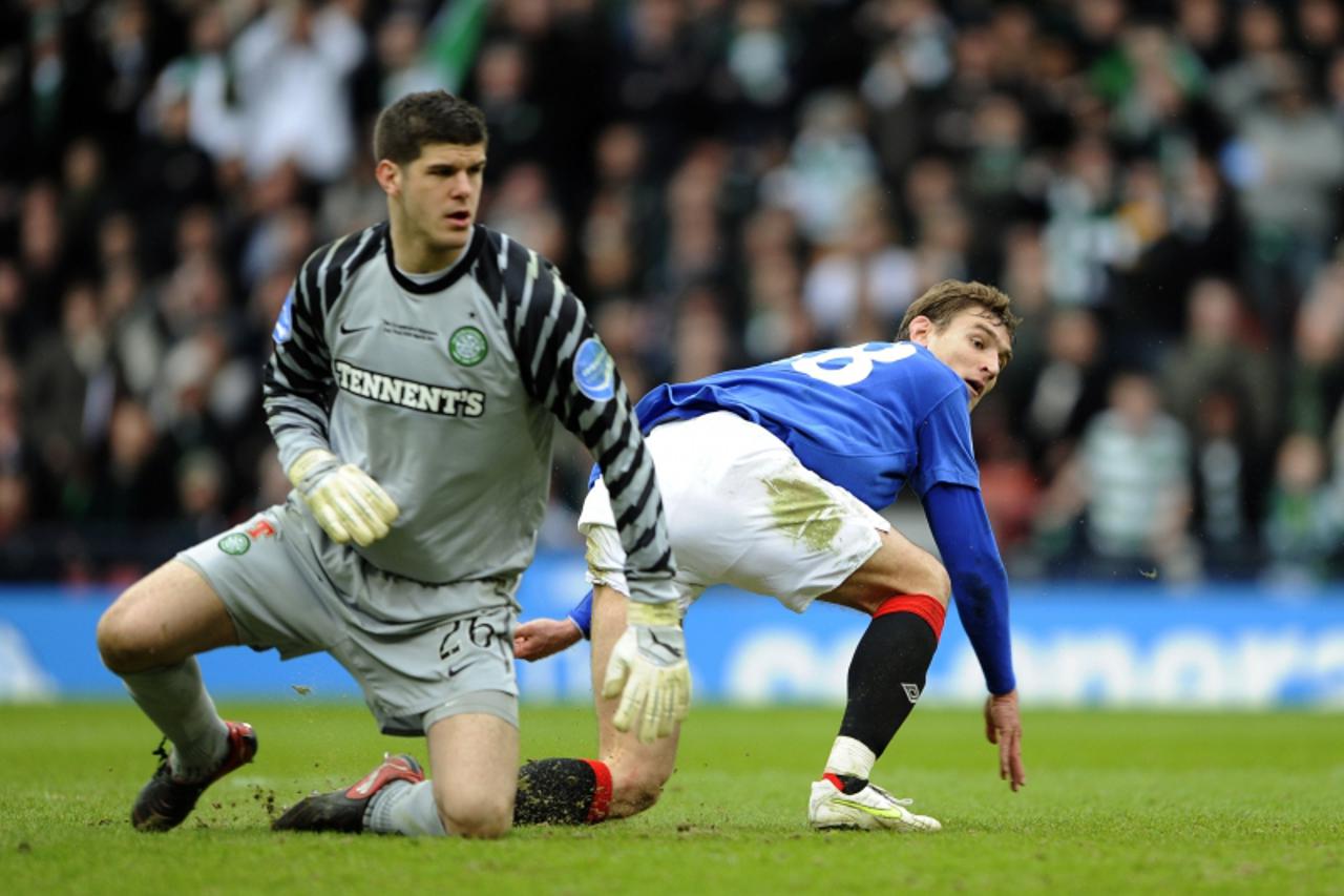 \'Rangers\' Nikica Jelavic watches with Celtic goalkeeper Fraser Forster as his shot goes in off the post during their Scottish League Cup Final soccer match at Hampden Park ,Glasgow, Scotland, March 
