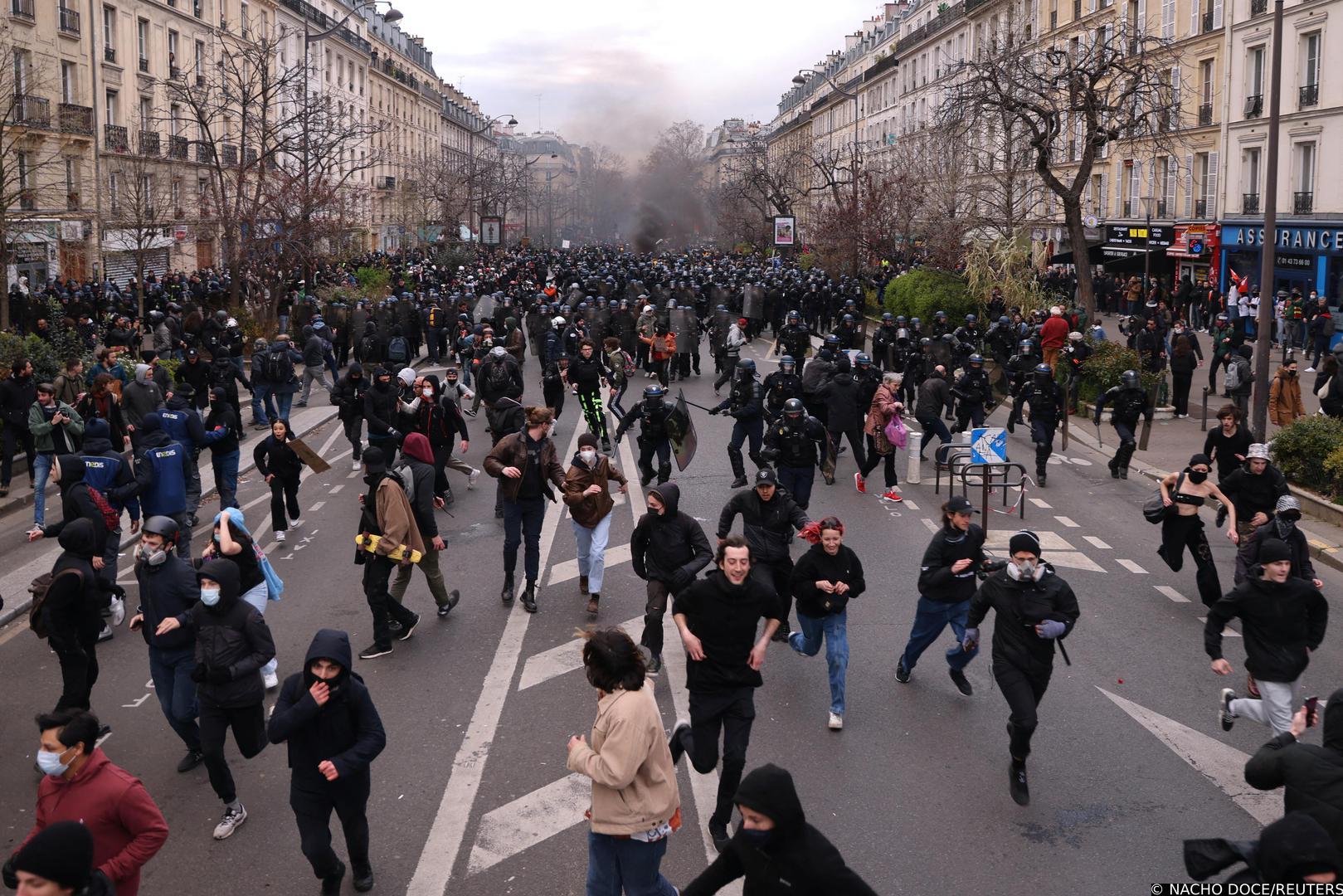 Protesters run in front of French riot police during clashes at a demonstration as part of the tenth day of nationwide strikes and protests against French government's pension reform in Paris, France, March 28, 2023.   REUTERS/Nacho Doce Photo: NACHO DOCE/REUTERS