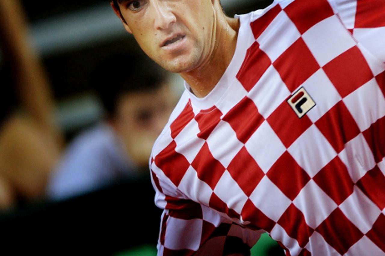 \'Croatian Marin Cilic returns a forehand against US James Blake during their quarterfinal Davis Cup tennis match in northern the Croatian adriatic resort of Porec, some 250 kilometers from Zagreb, on