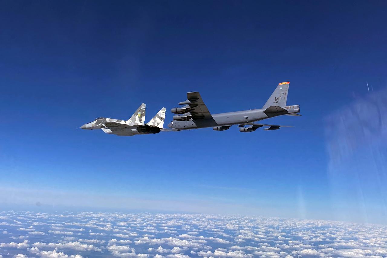 U.S. Air Force B-52 Stratofortress bomber, escorted by Ukrainian Air Force MiG-29 jet fighter, flies in Ukrainian airspace
