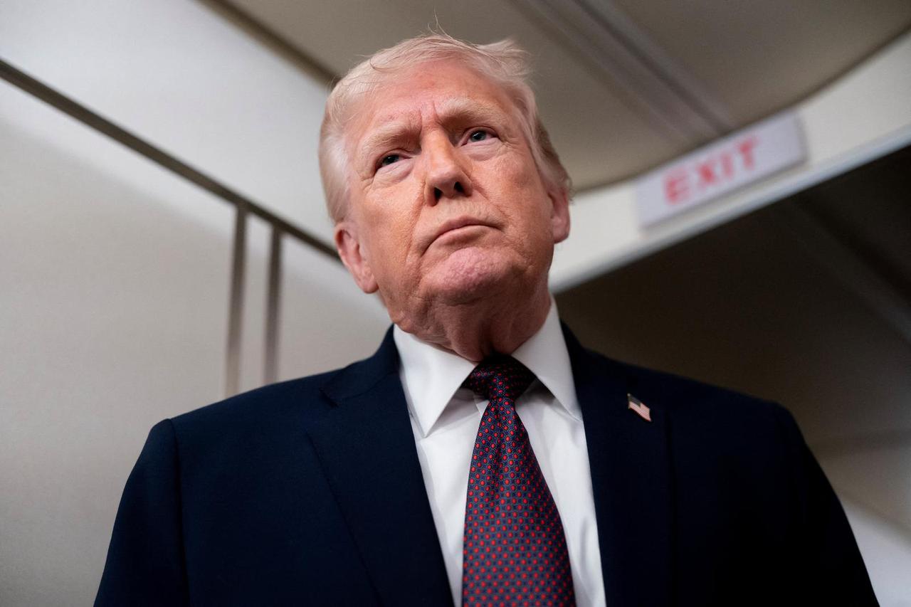 U.S. President Donald Trump speaks with members of the media aboard Air Force One en route to Joint Base Andrews