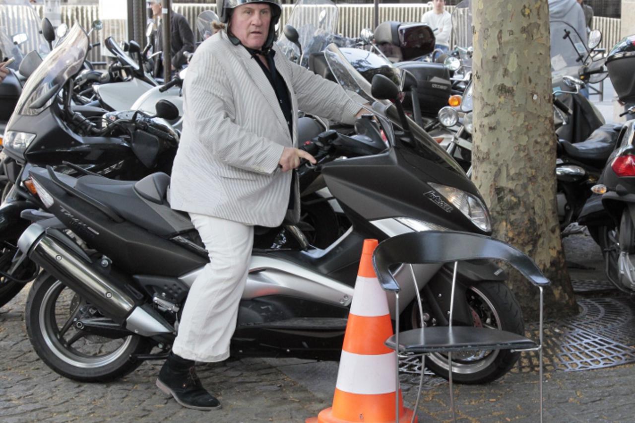 '(FILES) - A file picture taken on May 17, 2012 shows French actor Gerard Depardieu riding his motorbike in Paris. Depardieu has been accused of assaulting a motorist following a collision in Paris. T