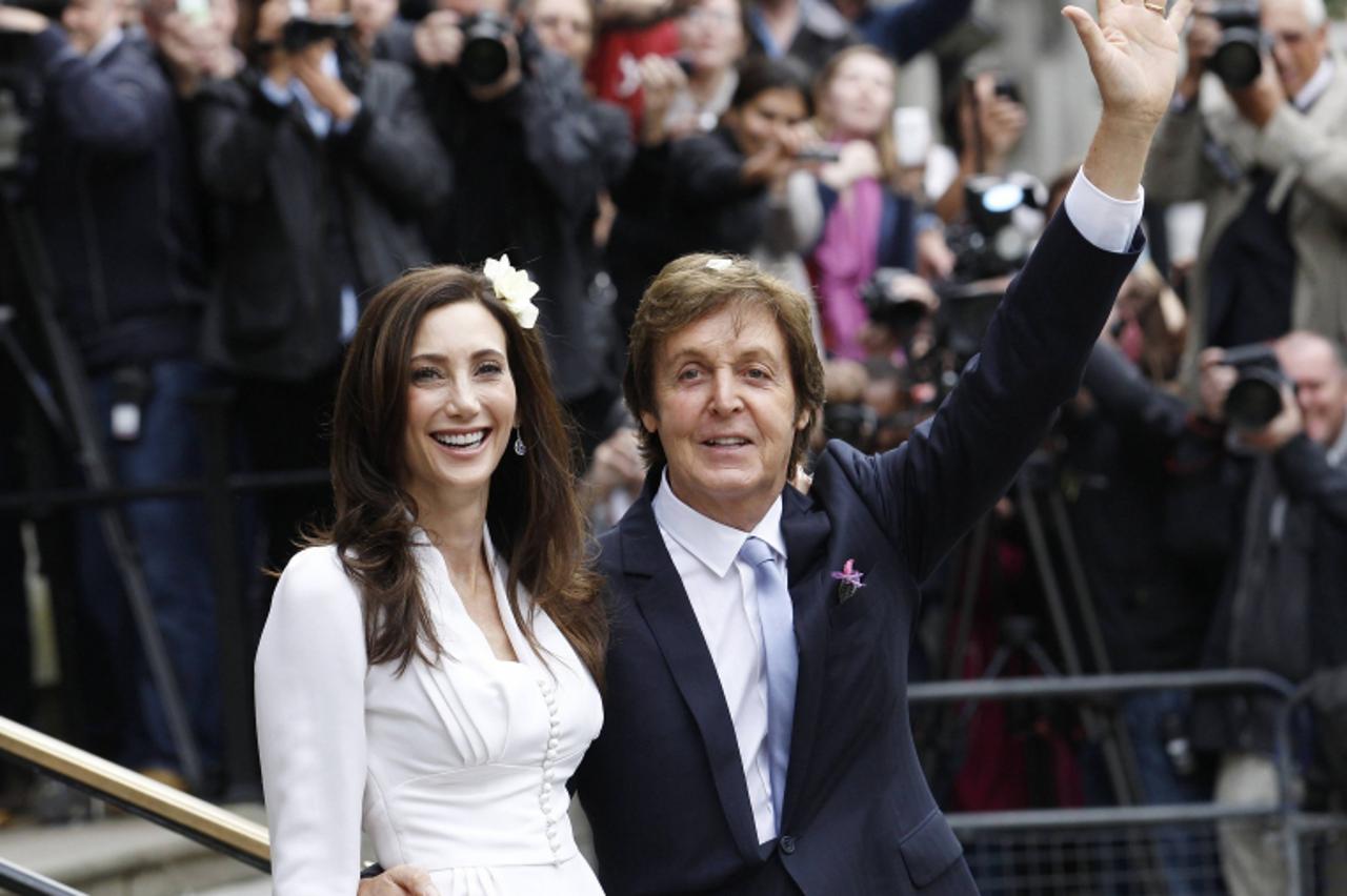 'Singer Paul McCartney and his bride Nancy Shevell leave after their marriage ceremony at Old Marylebone Town Hall in London October 9, 2011.  Former Beatle Paul McCartney wed for the third time on Su