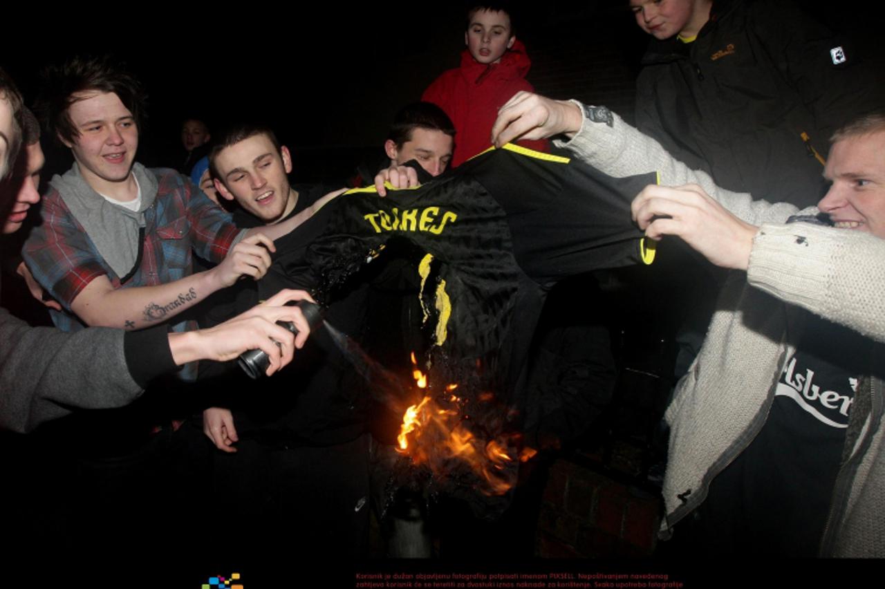'Liverpool fans burn a Fernando Torres shirt at Melwood Training Ground, Liverpool. Photo: Press Association/Pixsell'