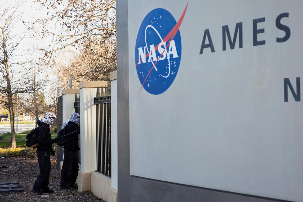 Protesters gather outside Moffet Federal Field where they expect federal agents to arrive before the Super Bowl LX